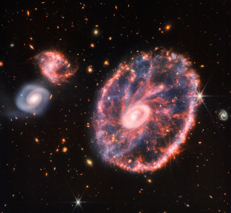 Телескоп Вебба детально сфотографував галактику «Колесо воза», приховану за хмарою пилу